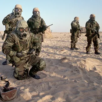 American soldiers, part of a U.S.-led coalition preparing to liberate Iraqi-occupied Kuwait, wear gas masks during a chemical warfare exercise in Saudi Arabia, in December 1990. 