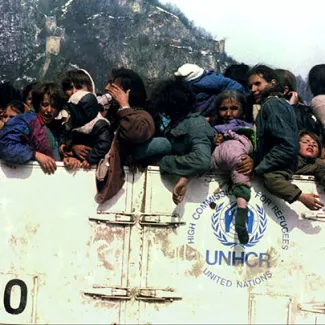 Muslim refugees are evacuated from Srebrenica, Bosnia and Herzegovina, in an overloaded UNHCR truck on March 31, 1993.