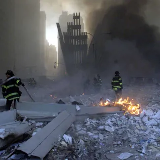 Firemen work around the World Trade Center after both towers collapsed in New York on September 11, 2001.