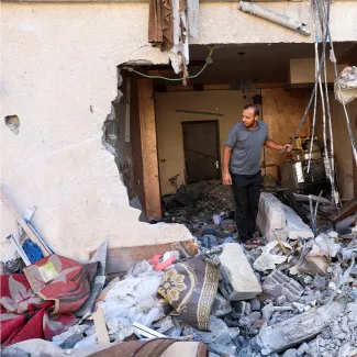 A Palestinian man checks a house that was damaged during Israel-Gaza fighting in Gaza City on August 8, 2022.