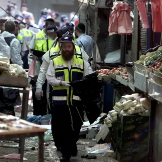 Israeli rescue workers search the scene of a suicide bombing in Netanya on May 19, 2002.