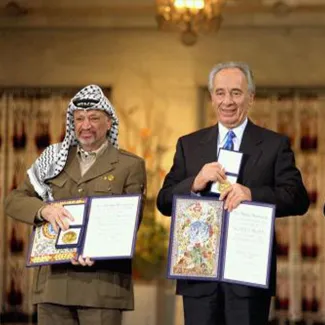 Israeli Prime Minister Yitzhak Rabin, Foreign Minister Shimon Peres, and PLO Chairman Yasser Arafat win the Nobel Peace Prize in 1994.