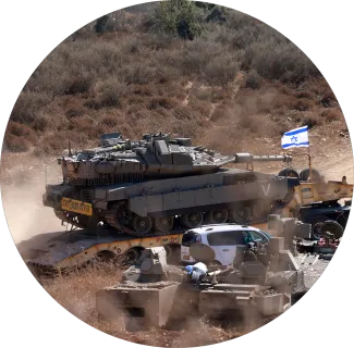 The Israeli military transports a tank to the Lebanese border in preparation for an assault.
