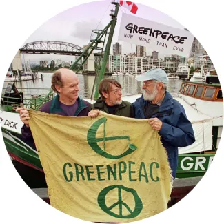 Founding members of Greenpeace Bill Darnell, Lyle Thurston, and Jim Bohlen hold the original banner in Vancouver, Canada on September 15, 1971.