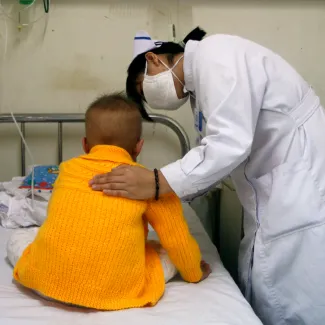 A nurse comforts a three-year-old patient in the HIV/AIDS ward of the Beijing YouAn Hospital October 28, 2008.