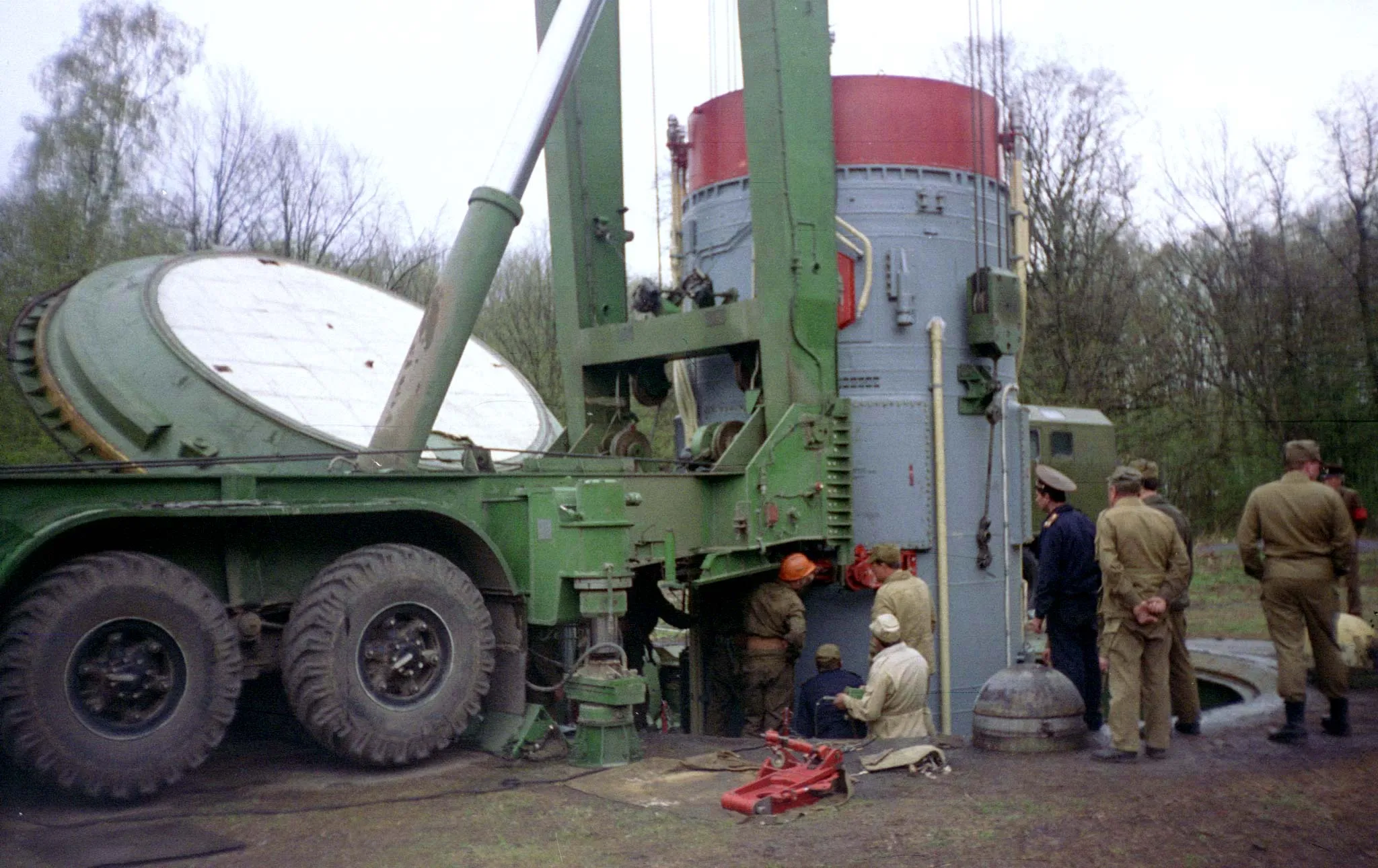 Workers remove warhead of the Soviet era SS-19 nuclear missile from the mine at a amilitary base near the Ukrainian town of Khmelnitsky as they prepare it to ship to Russia. 