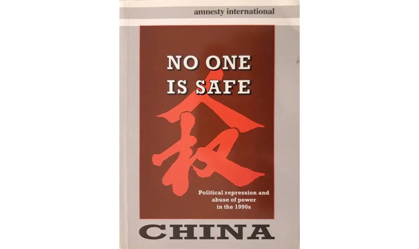 Cover of Amnesty International report title's "No One is Safe" with a red chinese character illustrated behind the title.