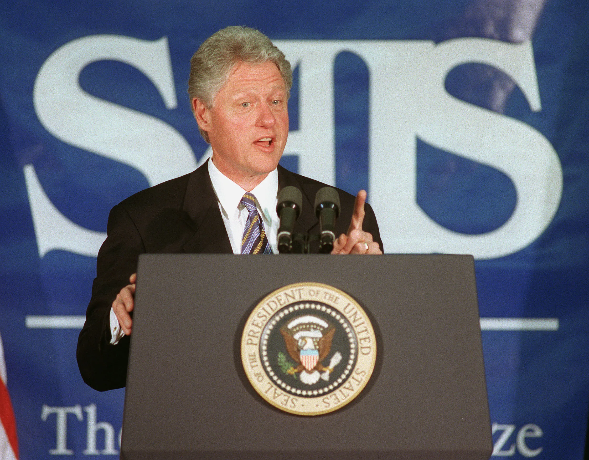 President Bill Clinton speaks from podium with presidential seal about trade and China.