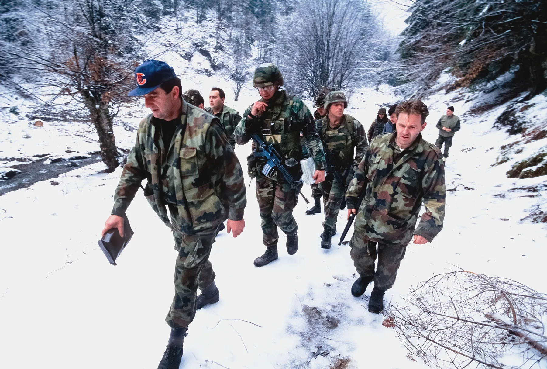 NATO-led military forces march in snowy landscape in Bosnia Herzegovina in winter 1995.