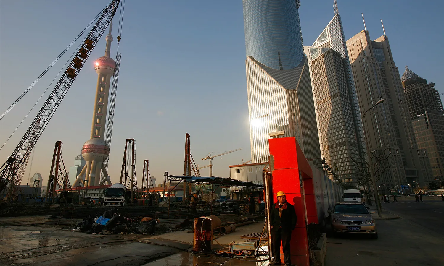 A worker rests at a construction site of new buildings in the Pudong Lujiazui Financial District in Shanghai on January 29, 2007.