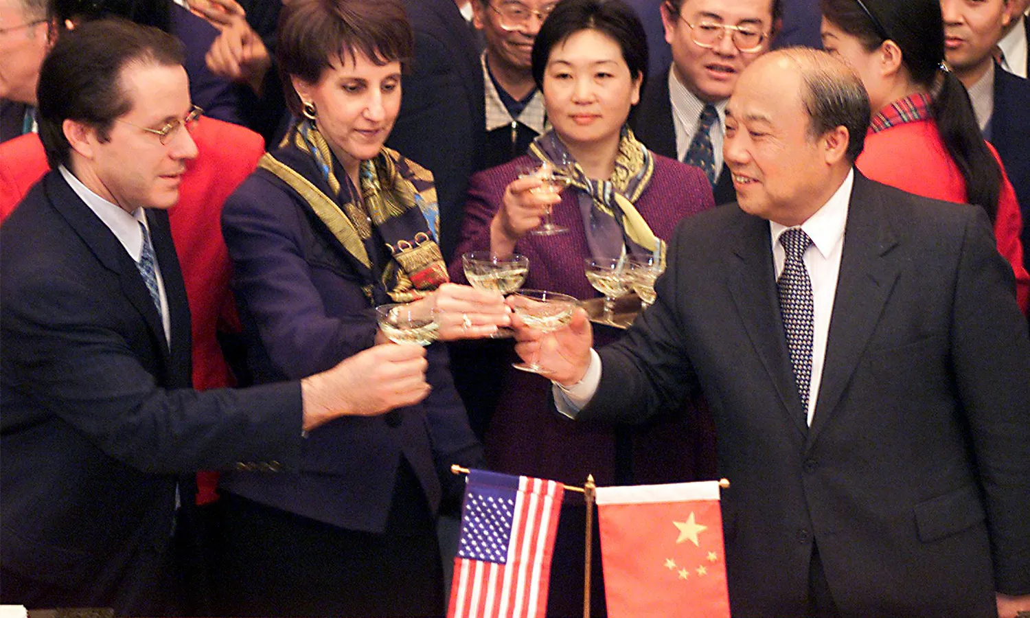 U.S. trade diplomats and Chinese officials toast to the signing of a bilateral agreement regarding China's accession to the World Trade Organization.